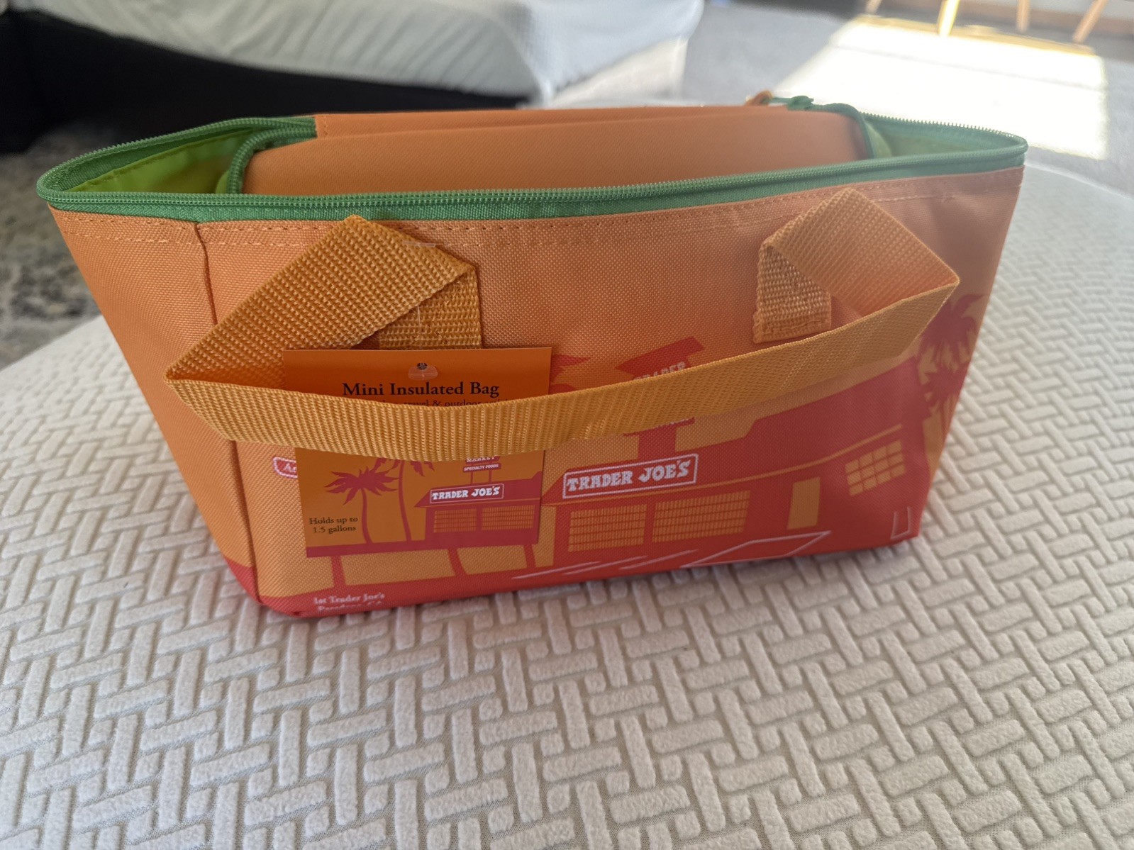 Trader Joe’s 2026 Mini Insulated Tote Sunny orange with green zipper.
